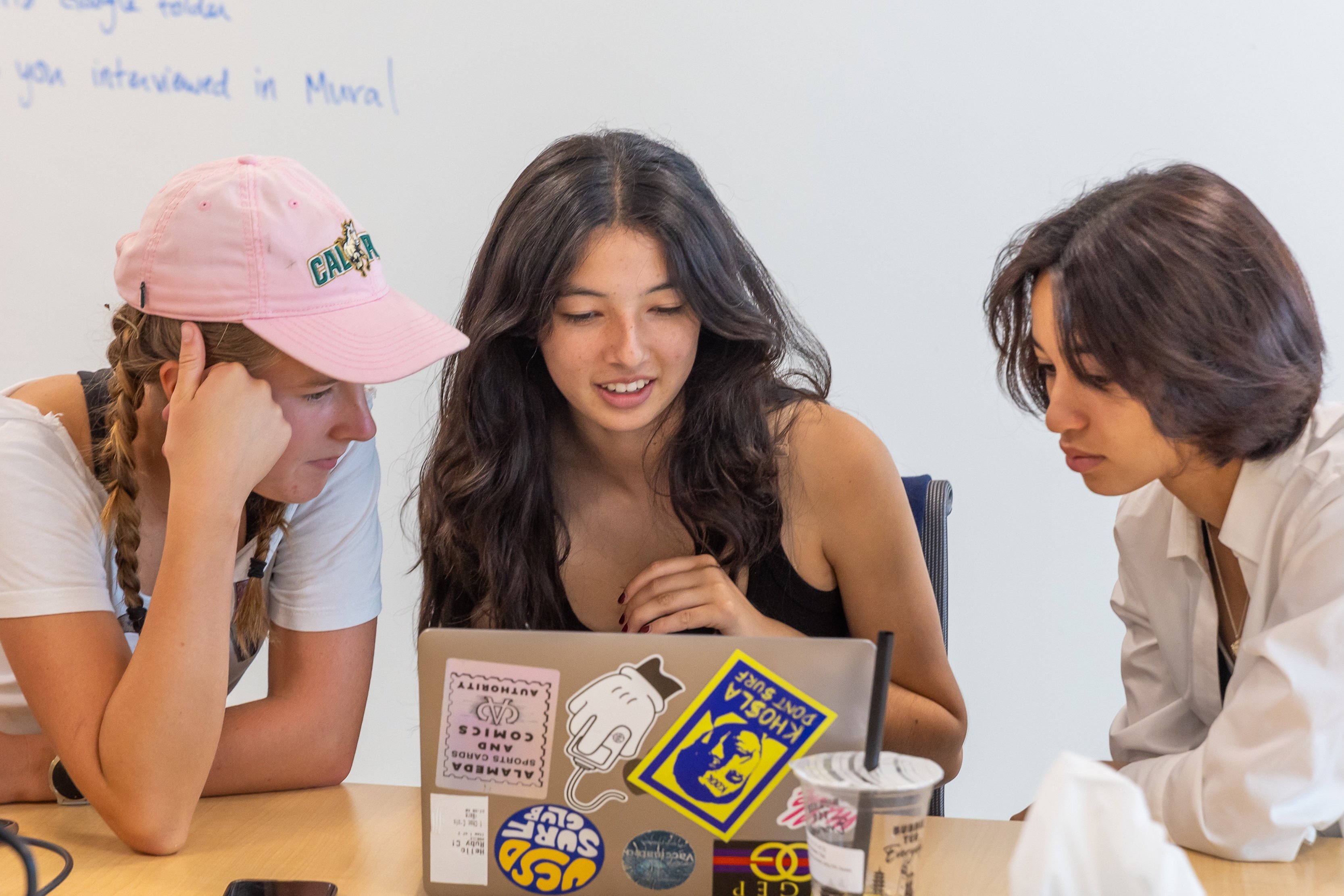 GURLS Program participants reviewing their service project on a laptop.